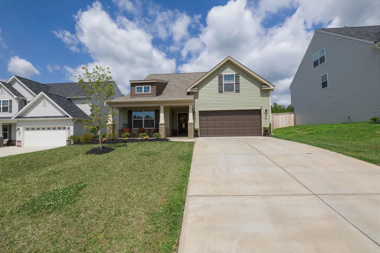 Two-story suburban home with a front lawn and driveway