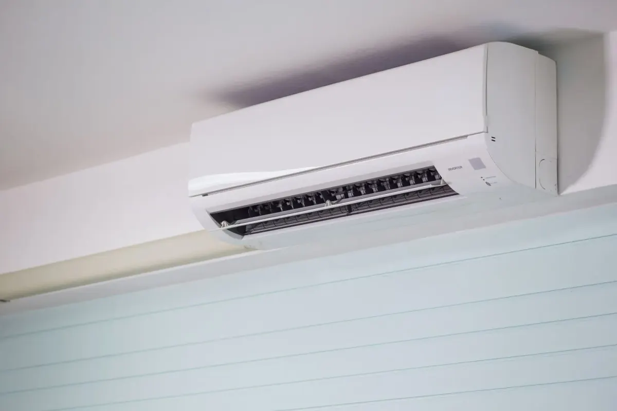 Ductless mini-split head mounted high on a white wall